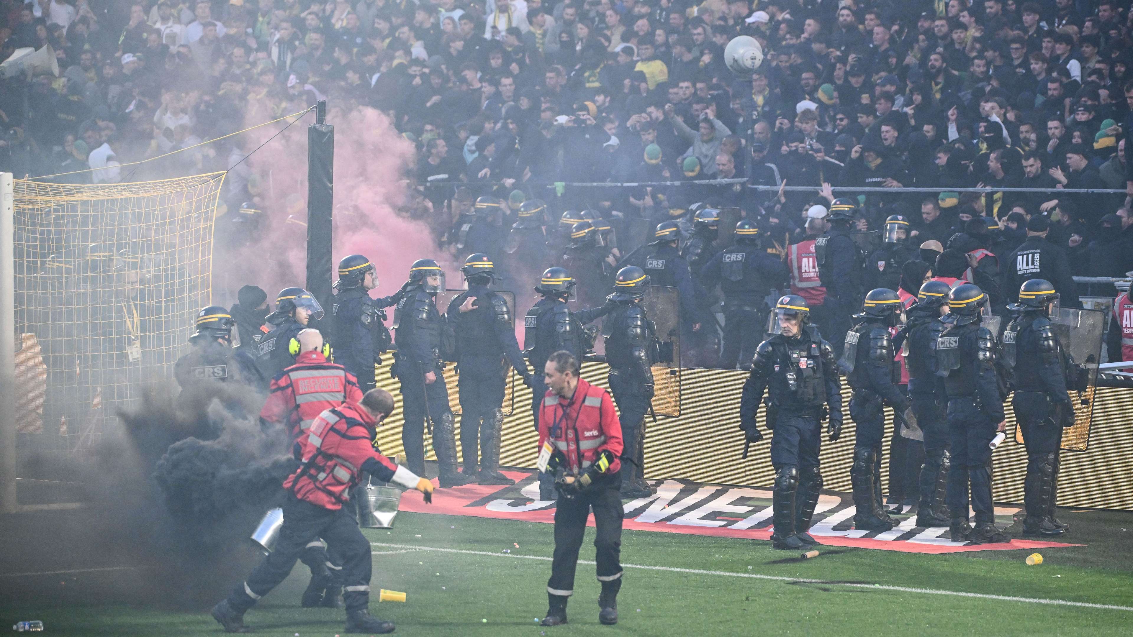Nantes Ultras Storm Pitch with Flares as Ligue 1 Match